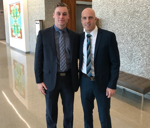 Two Driven Sports Group representatives in suits