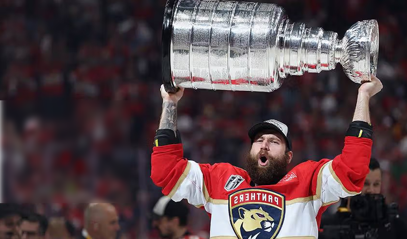 A Driven client lifting the Stanley Cup